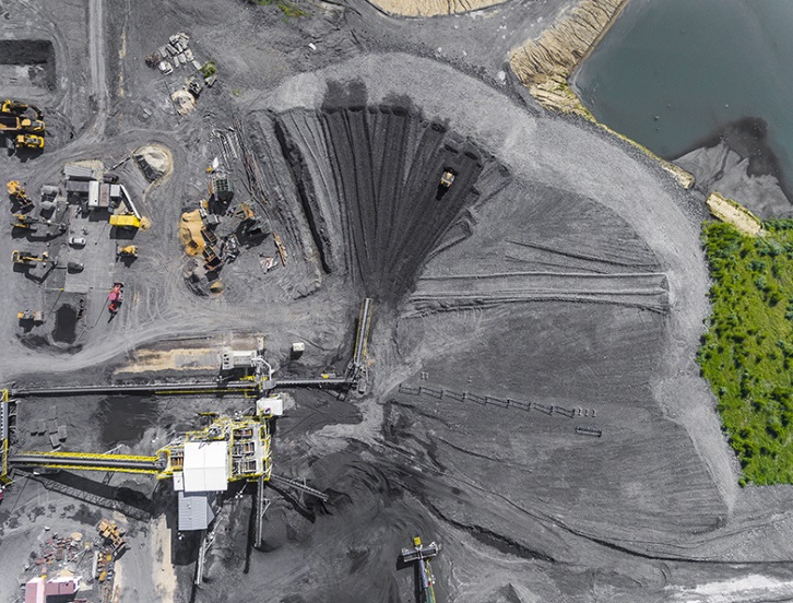 Black coal deposits. Exploration and machine. View from above.