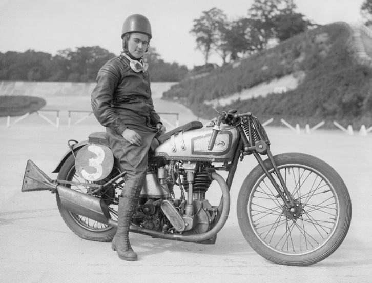 July 1935: Miss Beatrice Shilling sits astride her Norton motorcycle at the Brooklands race track. (Photo by Fox Photos/Getty Images)